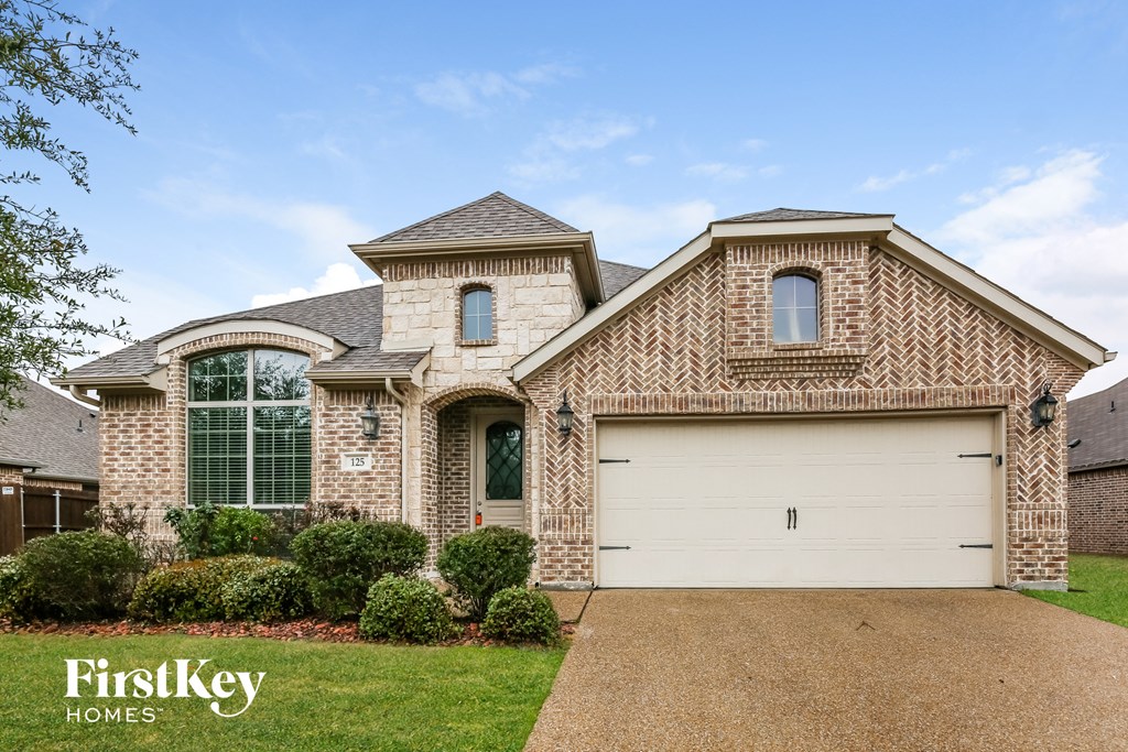 with a white garage door on a brick