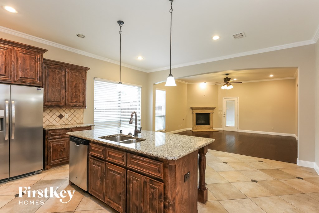 the kitchen is open to the living room and dining room