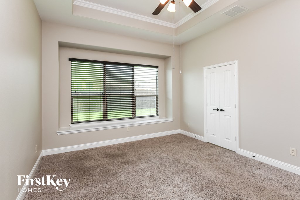 an empty room with a large window and a white door