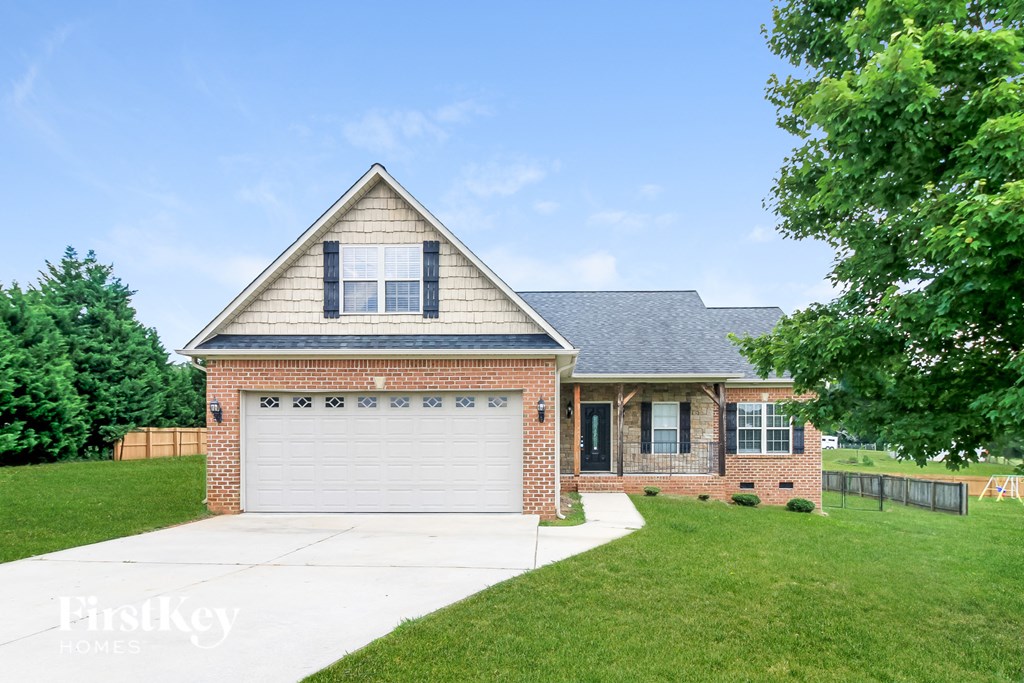 a brick house with a white garage door