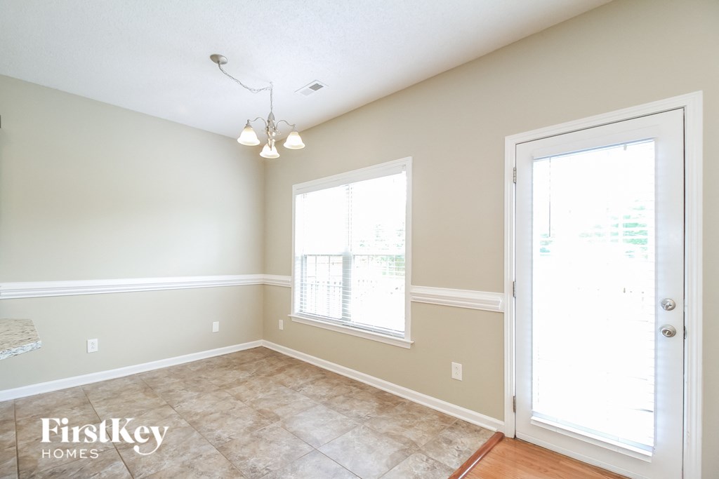 a dining room with a door and a window