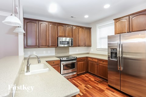 a kitchen with wooden cabinets and stainless steel appliances