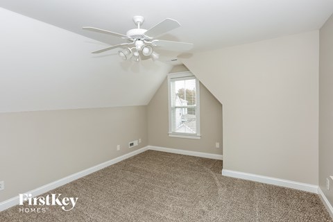 a bedroom with carpet and a ceiling fan