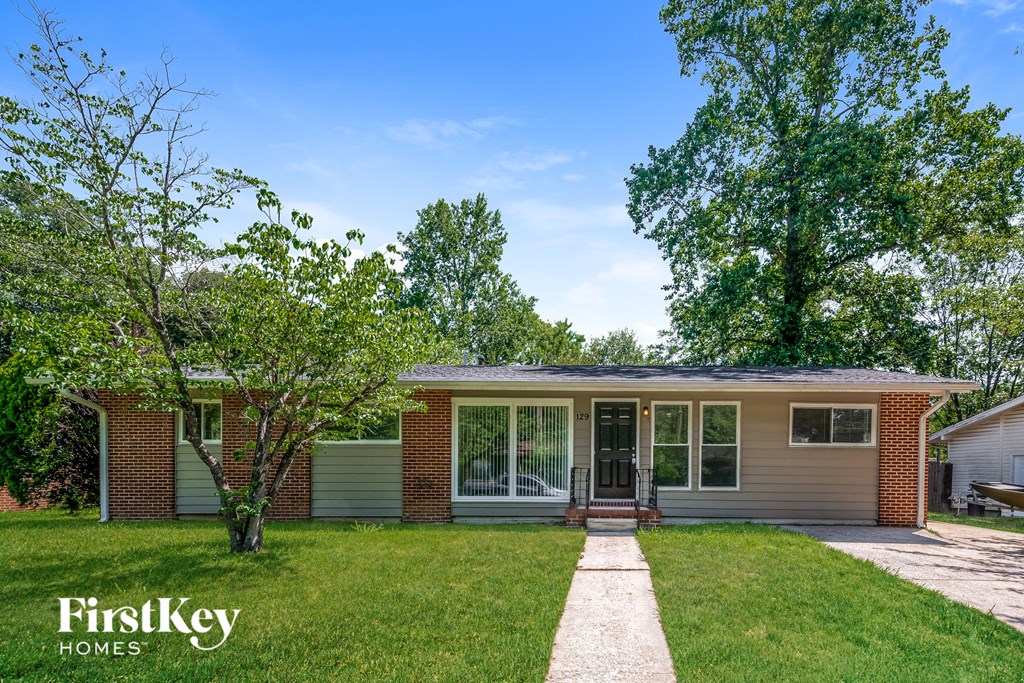 A house with a tree in front of it.