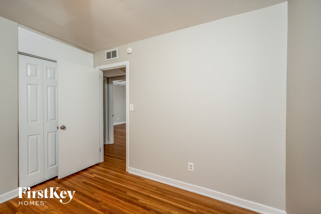 A room with a door and a wall socket.