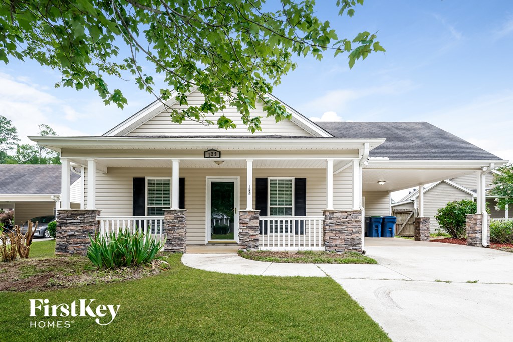 A house with a porch and a white picket fence.