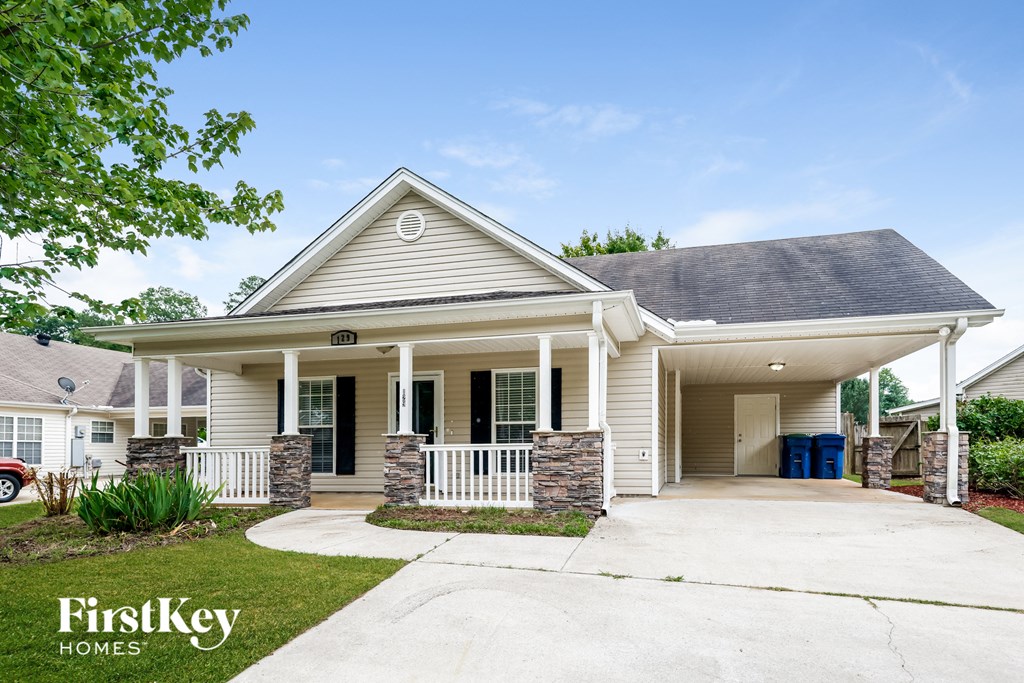 A house with a porch and a sign that says FirstKey Homes.