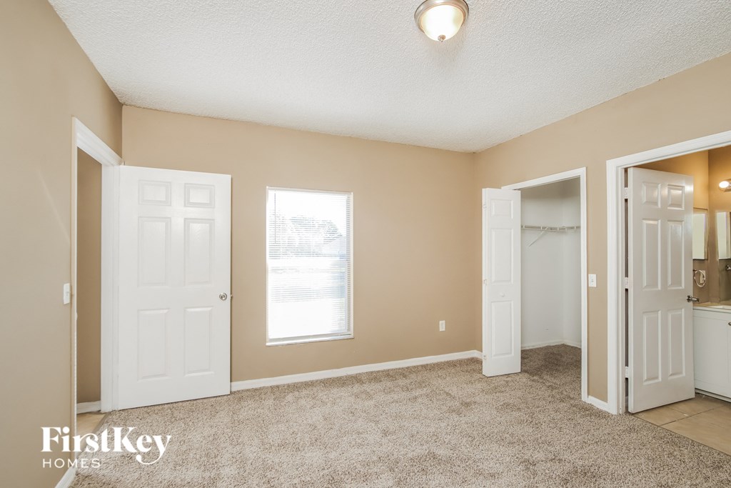 a bedroom with two closets and a door to a bathroom