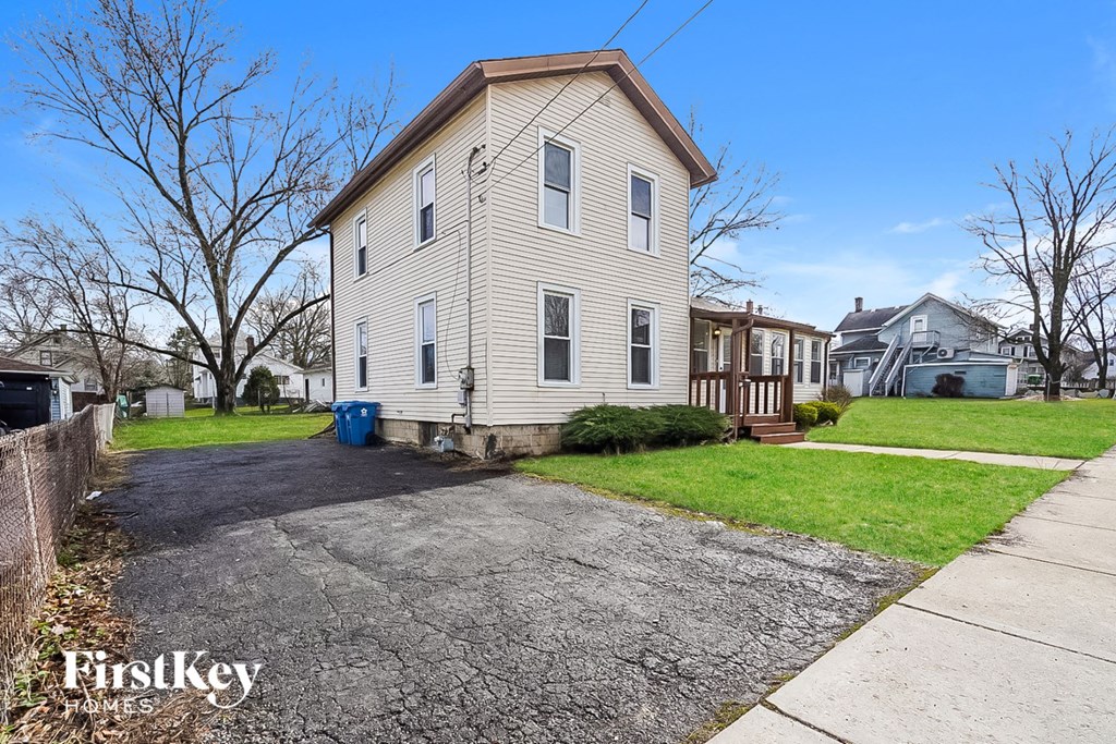 a white house with a driveway in front of it