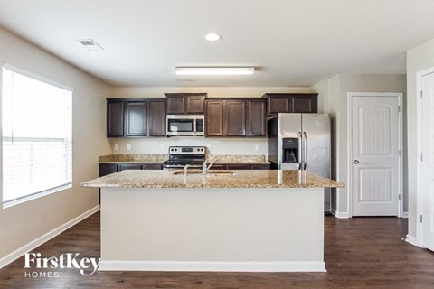 a kitchen with a counter top and a refrigerator