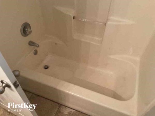 a white bath tub in a bathroom next to a sink