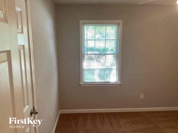 an empty room with a window and a door