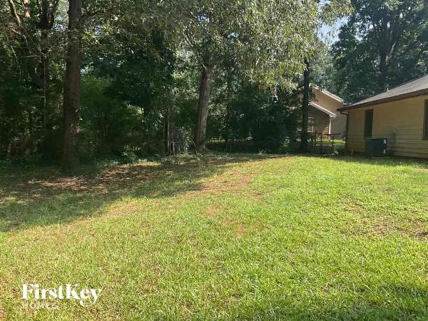 a yard with a house and trees