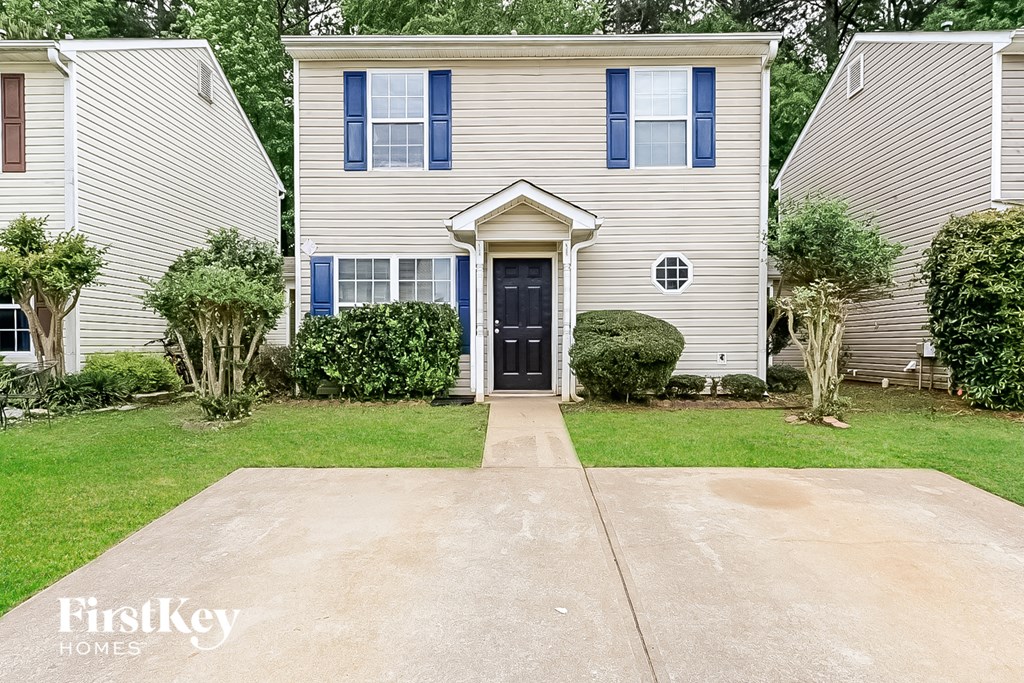 A house with a black front door and a small porch.