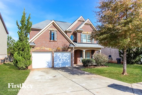 a brick house with a garage and a white garage door