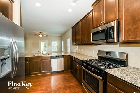 a kitchen with wooden cabinets and stainless steel appliances