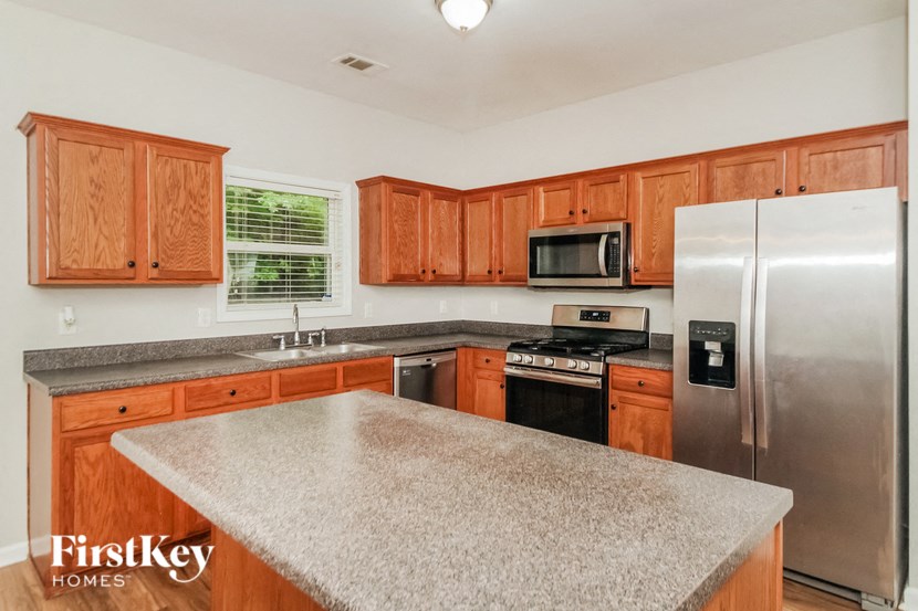 a kitchen with a counter top and a refrigerator