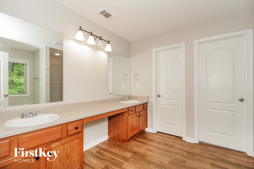 a bathroom with two sinks and a mirror