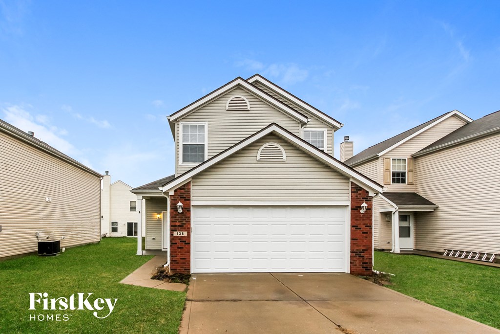 a side view of a house with a white garage door