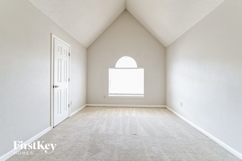 an empty room with a door and a window