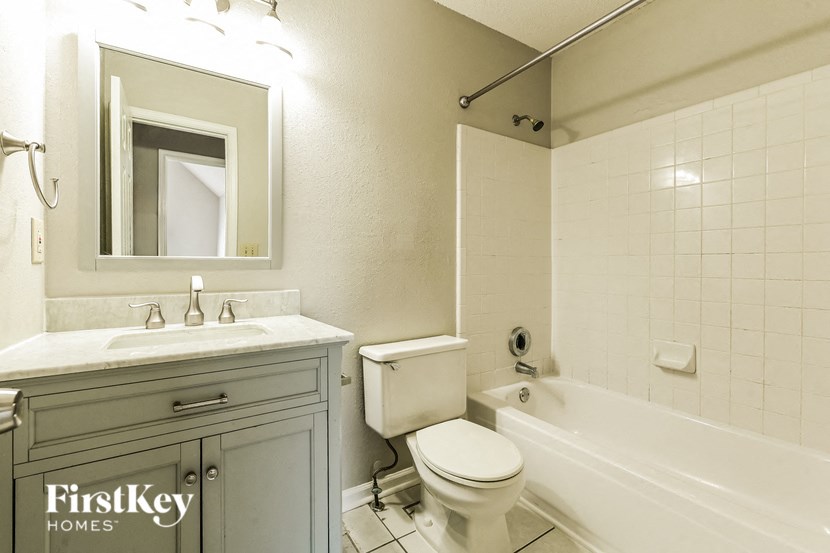 a bathroom with a sink toilet and bath tub
