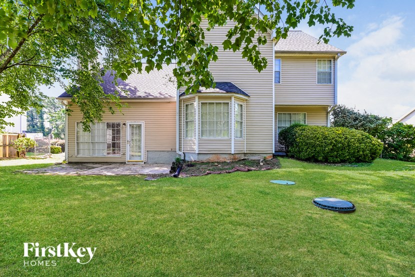 a house with a frisbee on the grass in front of it