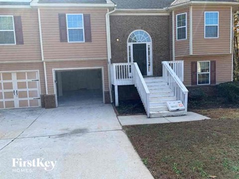 a house with a white porch and a driveway