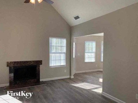 an empty living room with a fireplace