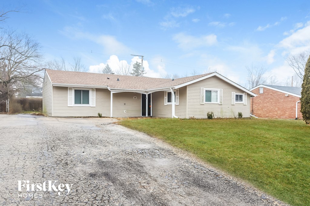 A house with a driveway in front of it.