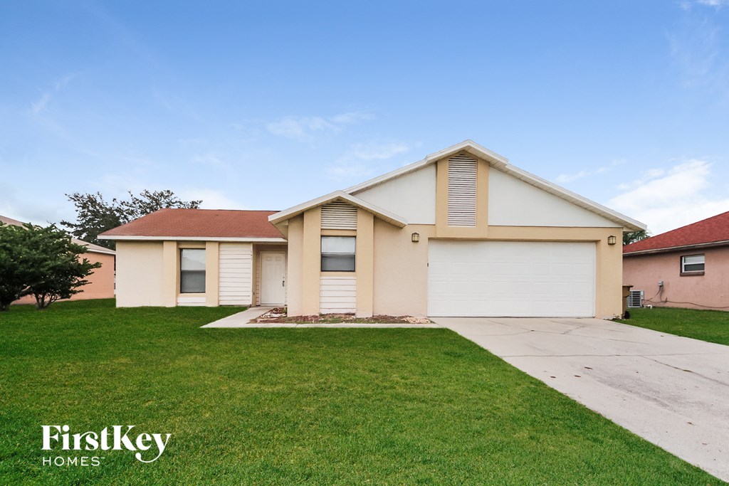 A two-story house with a garage is for sale.