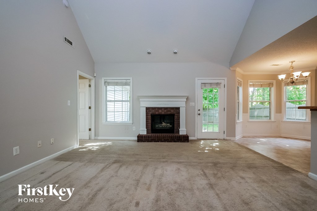 an empty living room with a fireplace in it
