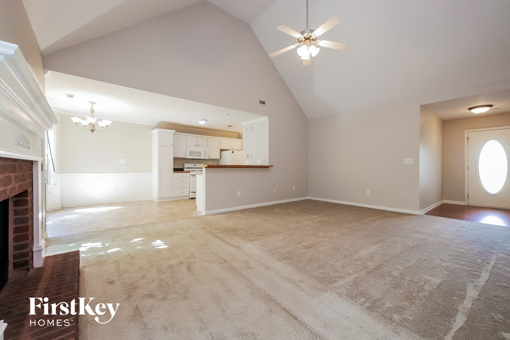 the living room and dining room with the kitchen in the background