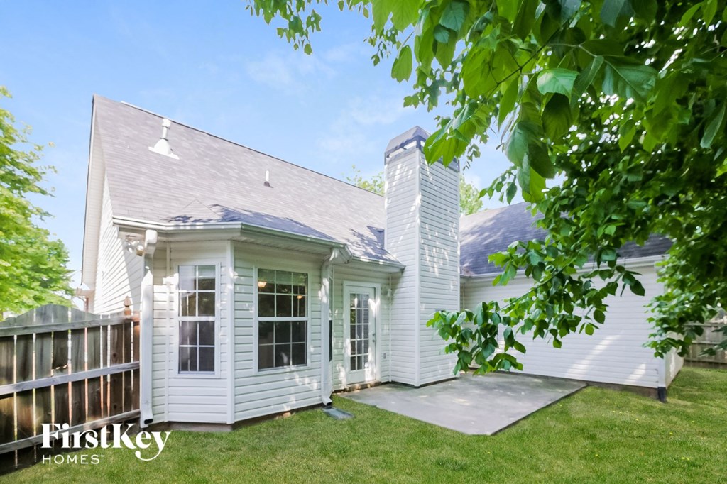 a white house with a gray roof and a porch