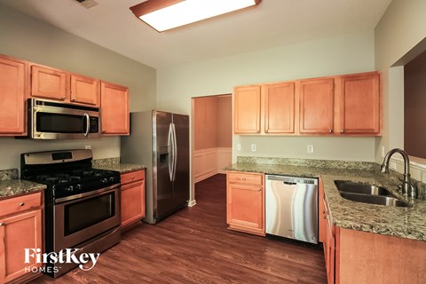 a kitchen with wooden cabinets and stainless steel appliances