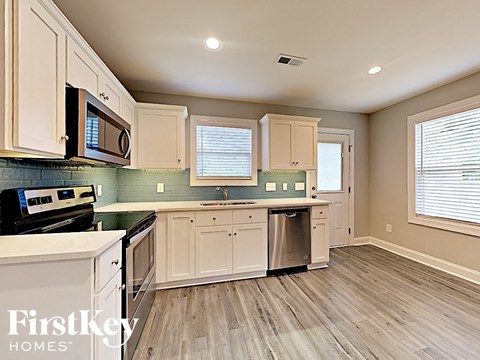 A kitchen with wooden cabinets and a stainless steel dishwasher.