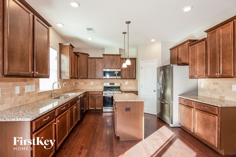 a kitchen with wooden cabinets and stainless steel appliances