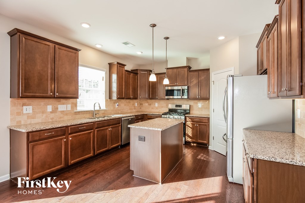 a kitchen with wooden cabinets and stainless steel appliances