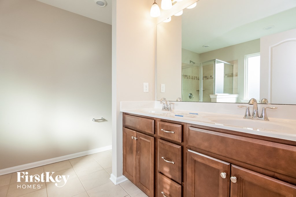 a bathroom with two sinks and a large mirror