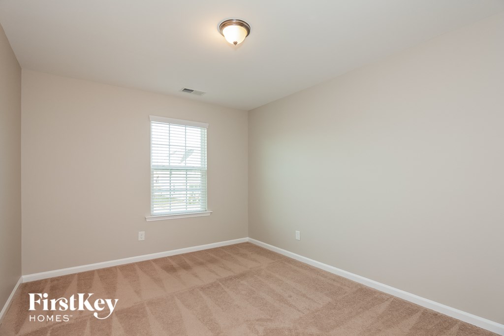 a white room with a wooden floor and a window
