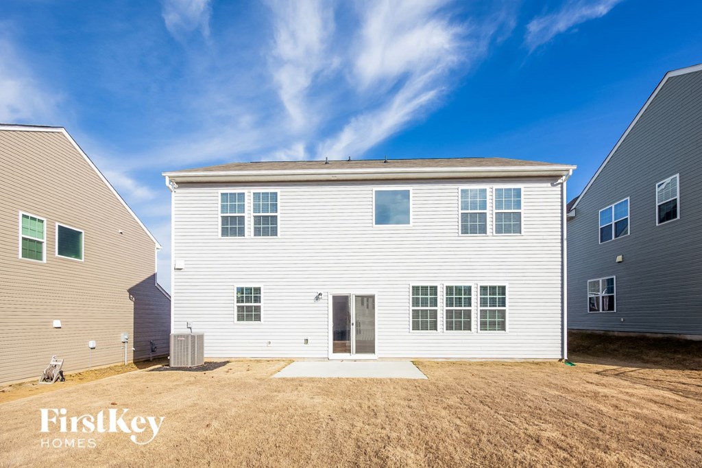 a white house with a yard in front of it