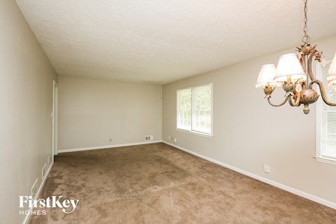 a living room with a carpet and a chandelier