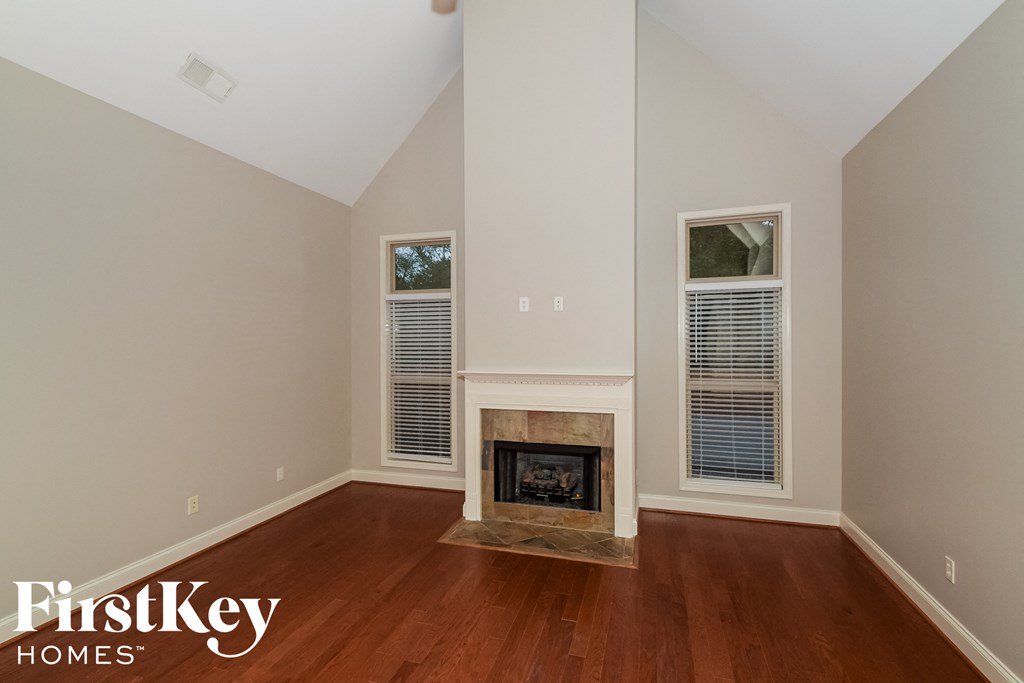 a living room with wood flooring and a fireplace