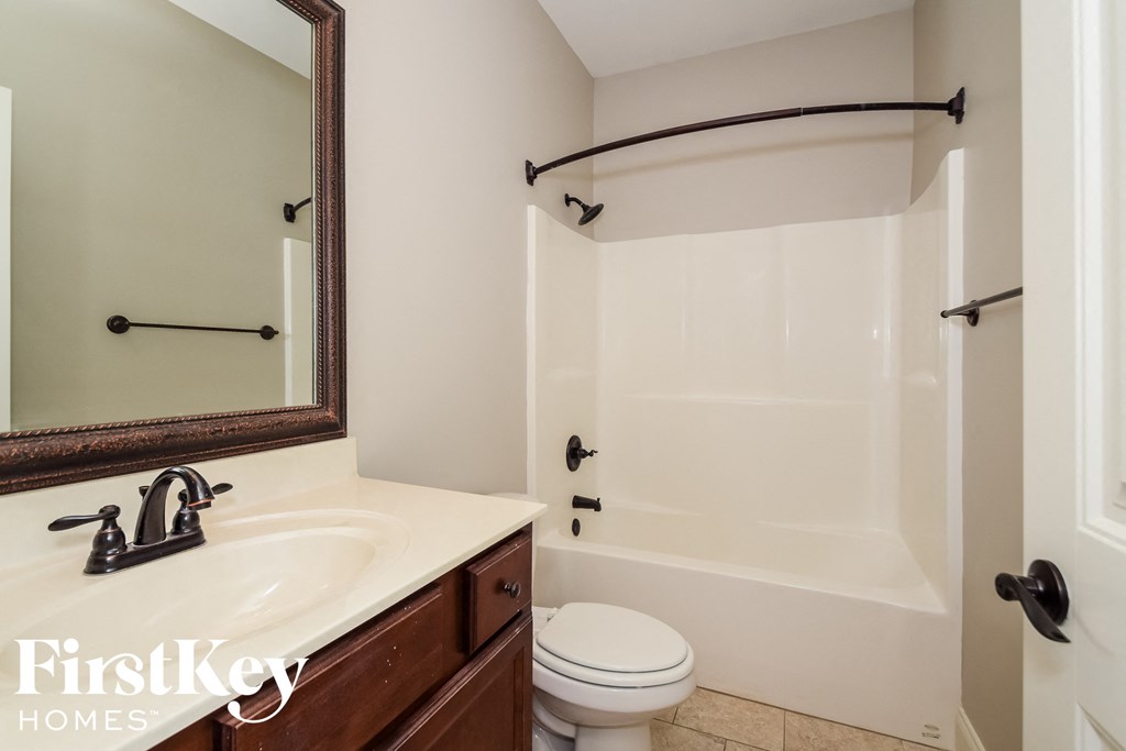 a bathroom with a sink and a shower and a toilet