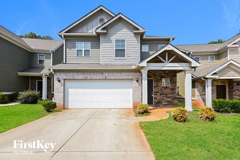 A large house with a garage is for sale by FirstKey Homes.