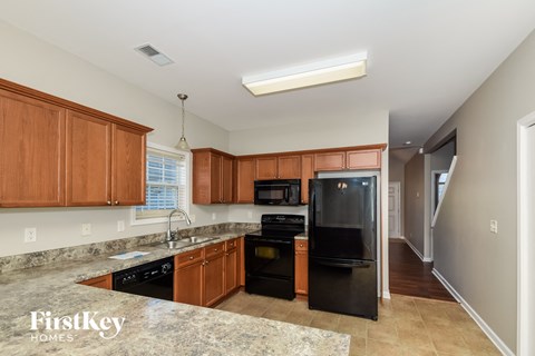 a kitchen with black appliances and granite counter tops