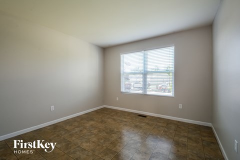 a empty room with a window and a tiled floor