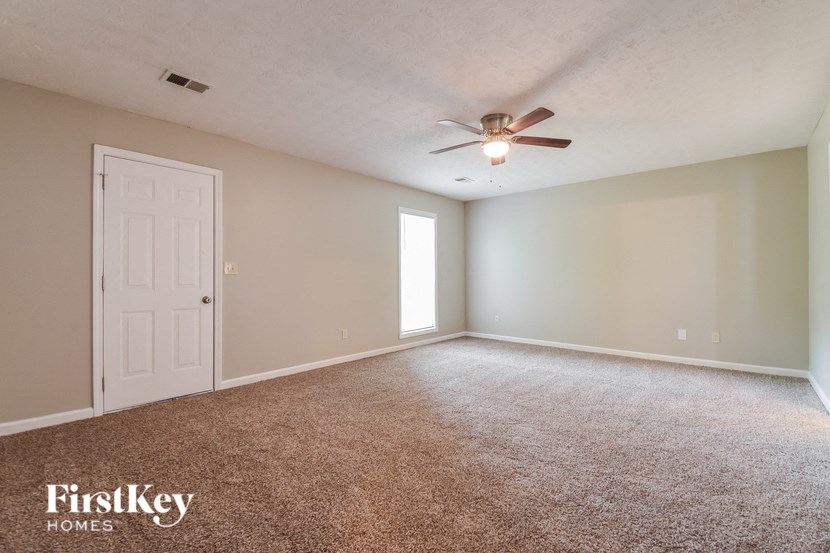 the master bedroom is spacious and has a ceiling fan