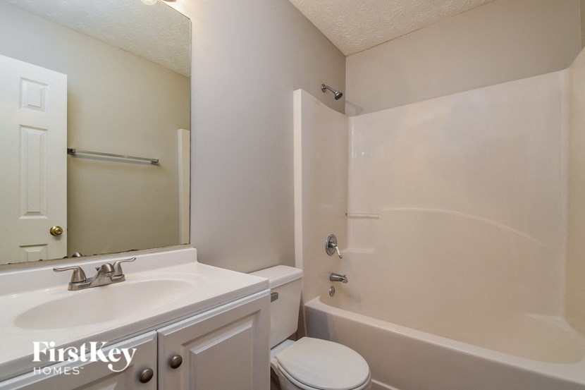 a bathroom with a sink and a tub and a toilet
