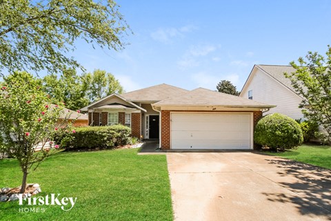 a house with a garage door and a lawn