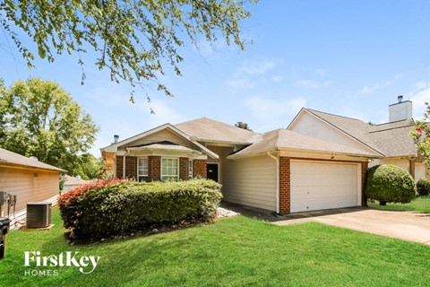 a house with a lawn and a driveway